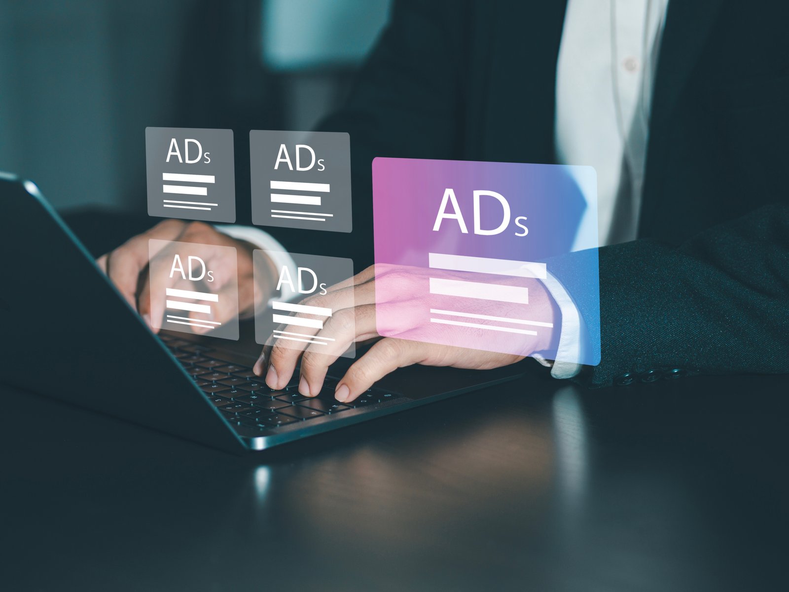 digital marketing concept Marketers analyze online advertising campaigns and performance indicators. Advertise on websites and social media Banner advertising on the internet. Hands typing on a laptop with translucent ad cards floating above the keyboard, suggesting digital advertising overlays.